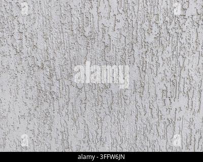 Light beige wall with rough surface plastered with cement. Texture and structure are clearly visible Stock Photo