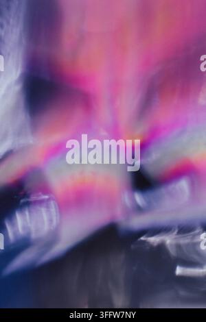 Abstract vertical background featuring soft motion blur, flowing light streaks, and blended pink, purple, and blue tones. Dreamy, atmospheric texture Stock Photo