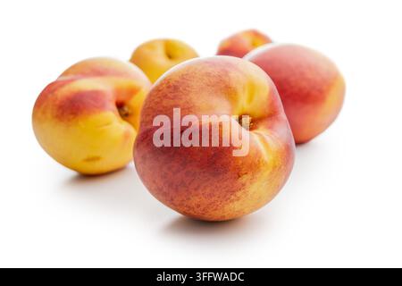 Bright, ripe nectarines arranged on a clean white background. Close-up composition highlights warm red and yellow tones, texture, and freshness,  idea Stock Photo