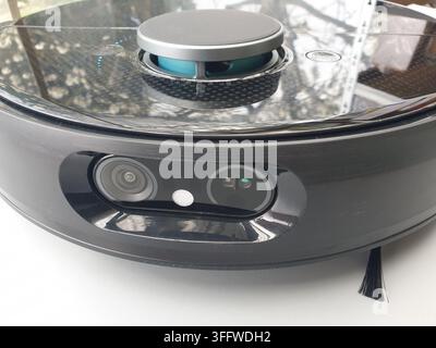 A closeup shows a modern robotic vacuum cleaners sensors and design Stock Photo