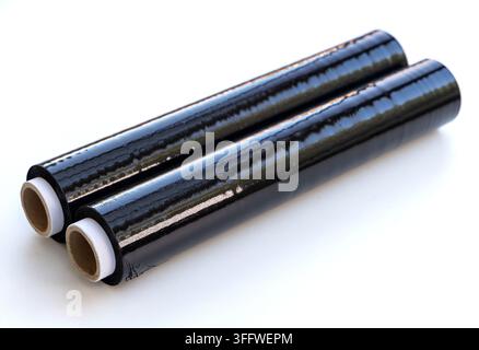 Two black stretch film rolls are isolated on a bright white background Stock Photo