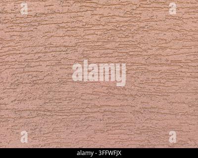 Close-up of beige textured plaster on a building house facade. Stock Photo