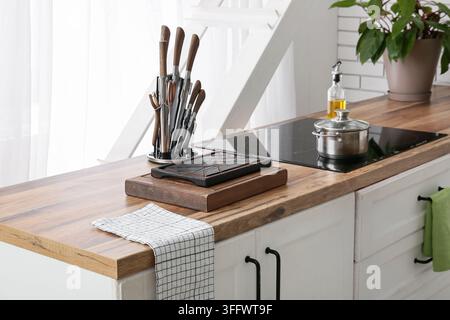 Wooden cutting boards with set of knives on counter in kitchen Stock Photo