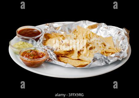 Traditional mexican nachos with melted cheese and fresh dips Stock Photo
