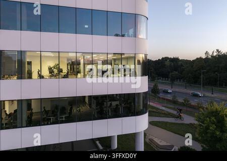 Aerial view of the modern illuminated office building in the city ...
