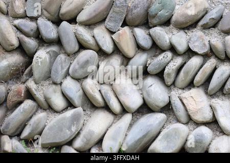 Close Up Texture of Traditional River Pebble Stone Wall Masonry in Mtskheta, Georgia Stock Photo