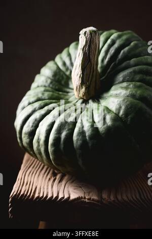 Two orange mini pumpkins on rustic wooden table close up. Decorative fall setup featuring Baby Boo squash in soft seasonal light Stock Photo