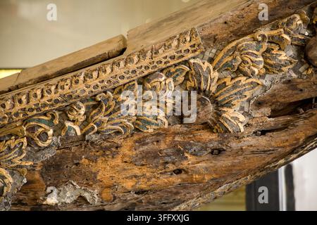 Seamless textured background of weathered teak wood featuring hand-carved floral patterns and embedded vintage mirror glass mosaic. Stock Photo