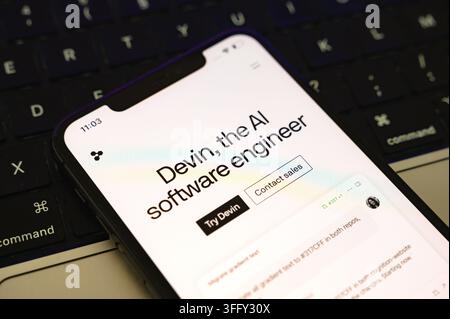 Paris, France - September 10, 2026 : Devin AI software engineer webpage on smartphone over keyboard. Stock Photo