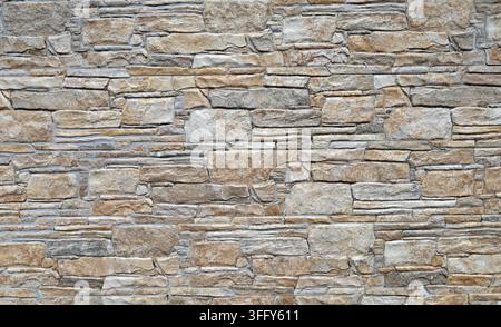 Stoneware paneling wall with rock effect. Colors are shade of brown,gray and white.Background and texture. Stock Photo