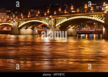 A stunning long exposure photograph of an iconic bridge spanning the Danube River in Budapest at night. Illuminated architecture and flowing water cre Stock Photo