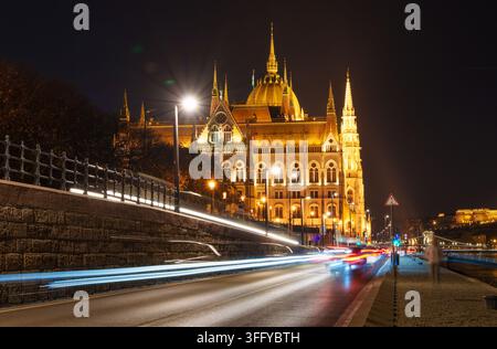 Stunning long exposure photograph of Budapest Hungary's iconic Parliament building at night. Bright car light trails enhance this dramatic architectur Stock Photo
