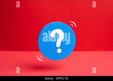 A question mark on a blue circle. FAQ and information. Questions and answers. Concept of customer support and knowledge base. Symbol of help and guida Stock Photo