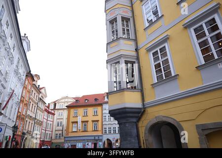 Prague, Czech Republic - August 26, 2026: Woman cleaning windows of a historic building in the Old Town. Stock Photo