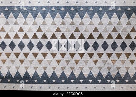 Geometric Triangle and Diamond Pattern in Neutral Tones. Close view of a neutral geometric pattern with repeating triangles and diamonds in beige Stock Photo