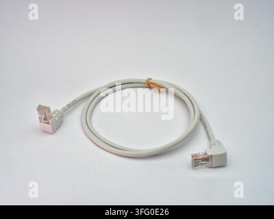 Ethernet Cable with Angled Connectors - A coiled white Ethernet cable with angled RJ45 connectors on a clean white background, ready for network conne Stock Photo