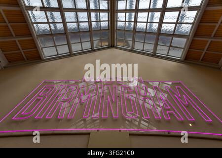 “Made in Birmingham” pink neon sign displayed inside Birmingham Museum and Art Gallery, celebrating the city’s creative identity, industrial heritage Stock Photo
