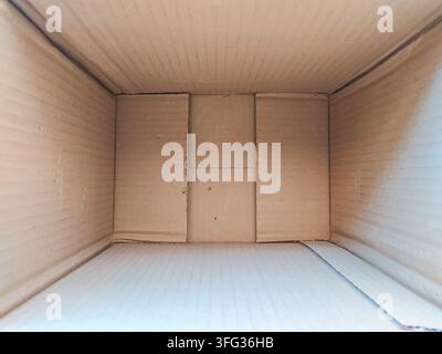 Look inside an empty cardboard box, a stark symbol of transition and new beginnings. This minimalist perspective evokes feelings of limitless potentia Stock Photo