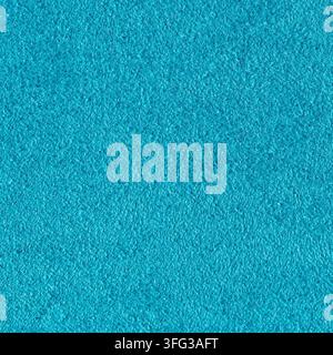 Detailed macro view of a bright teal textile showing a dense felted fiber structure with a smooth tactile finish under even light Stock Photo