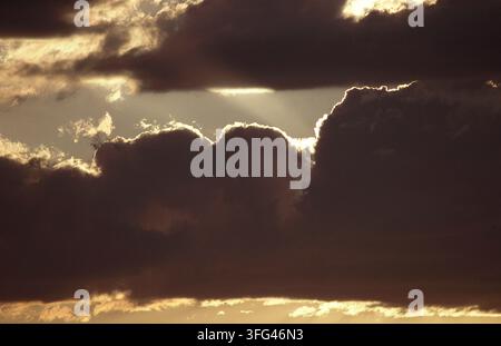 SUNLIGHT STREAMING THROUGH DARK STORM CLOUDS OVER SOUTH STRADBROKE ISLAND, MORETON BAY, QUEENSLAND'S GOLD COAST, AUSTRALIA. Stock Photo