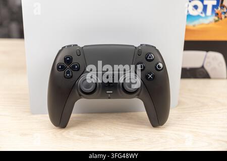 Bogota, Colombia - August 2026 Playstation 5 slim console standing next to its retail box with bundled video games Stock Photo
