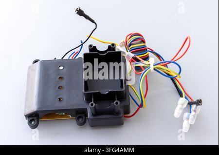 An electronic circuit module with colorful wires is displayed on a white background Stock Photo