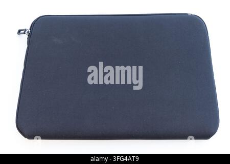 A dark blue neoprene laptop sleeve lies on a clean white background Stock Photo