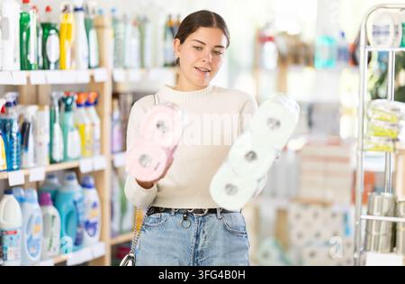 Woman choosing toilet paper kits Stock Photo