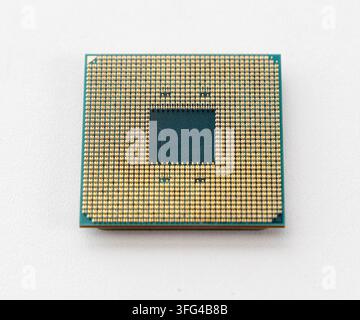 This image displays a computer processors gold pins on a clean white surface Stock Photo