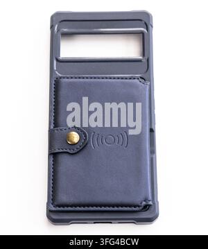 A protective smartphone case with a wallet attachment lies on white Stock Photo