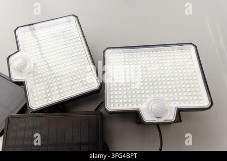 Two rectangular solar LED lights with motion sensors are displayed Stock Photo