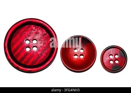 Three red textured sewing buttons arranged in a row by size from large to small on a clean white background, creating a concept of progression. Stock Photo