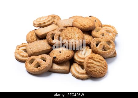 Pile of assorted butter cookies and biscuits in different shapes and textures isolated on white background. Stock Photo