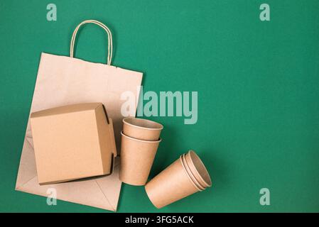 kraft paper shopping bag, takeaway box and disposable cups. Sustainable zero waste packaging concept with copy space. Stock Photo