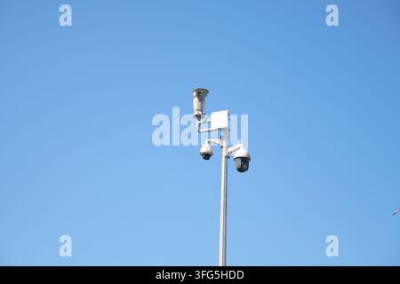 Surveillance cameras mounted on a tall pole Stock Photo