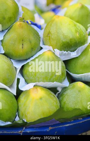 Fresh green figs in a market basket Stock Photo