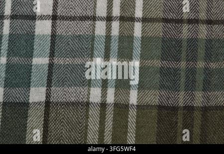Brown and green tartan flannel shirt pattern background with plaid clothing design. Stock Photo