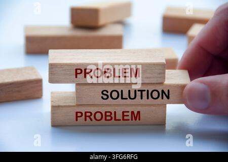 Hand holding wooden block representing a straightforward approach to resolving problems and finding solutions Stock Photo