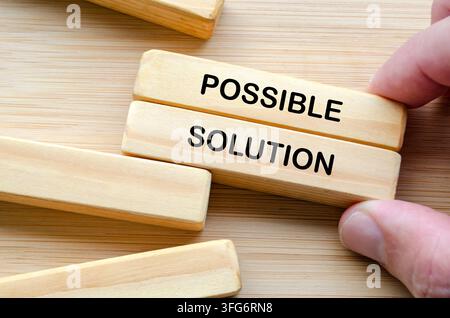 Hand holding wooden blocks representing structured problem solving with possible solution. Stock Photo