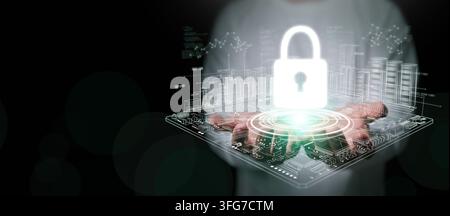 Cybersecurity concept. A man with both hands holding glowing padlock icon over digital circuit board with data servers for system protection, security Stock Photo