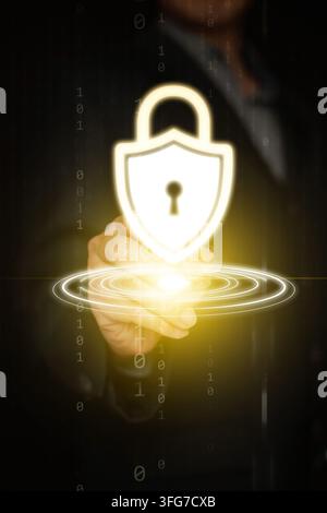 Cybersecurity concept. A businessman hand with stylus tapping at glowing shield padlock for system and data protection, privacy, security, and safety Stock Photo