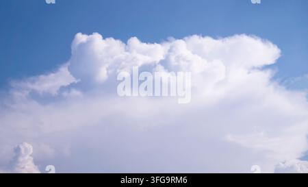 Massive White Cumulus Cloud Formation Against Clear Blue Summer Sky Stock Photo