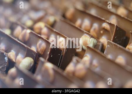 Dark chocolate bars with nuts in a sweet shop display Stock Photo