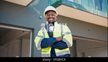 Portrait, man and supervisor at construction site with arms crossed, smile and engineering expertise. Happy, engineer or black person outdoor with Stock Photo