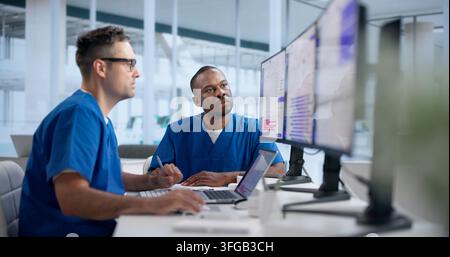 Clinical Trial Manager Reviews Patient Enrollment Data On Laptop Carefully. Stock Photo