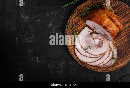 Christmas food. Festive Roasted Pork Belly Roll with Herbs and Rustic Styling Stock Photo