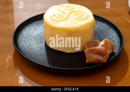 Creamy golden French handmade on farm butter from Brittany and caramel candies with sea salt flavor. Premium artisanal dairy product of Brittany. Stock Photo
