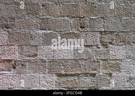 Full frame texture background of ancient porous medieval stone masonry blocks in Barcelona's Gothic Quarter Stock Photo