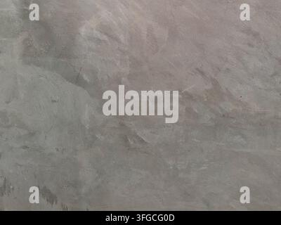 Grey polished concrete wall texture with natural weathered patterns, ideal for industrial, grunge, and minimalist backgrounds. Stock Photo
