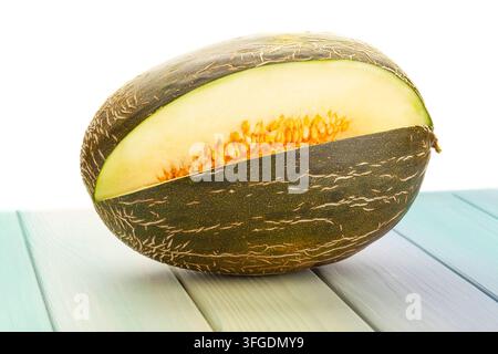 sliced christmas melon on wood background on white Stock Photo